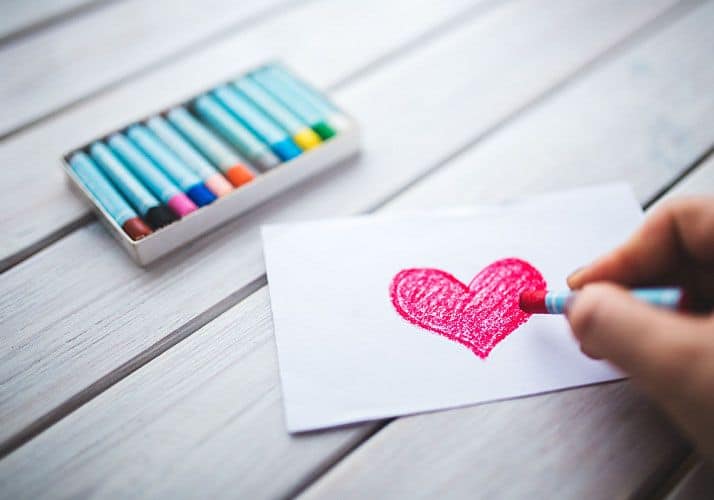 Drawing of a pink heart with crayons