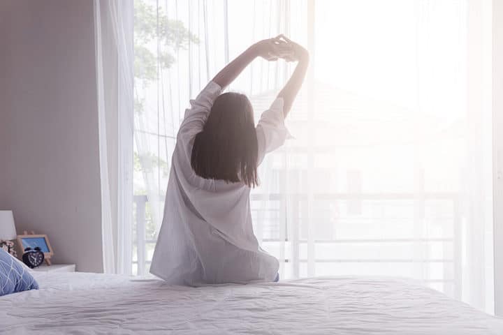 Sleep Woman waking up and stretching